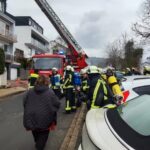 Feuerwehreinsatz mit Drehleiter und Einsatzkräften in Wohnstraße
